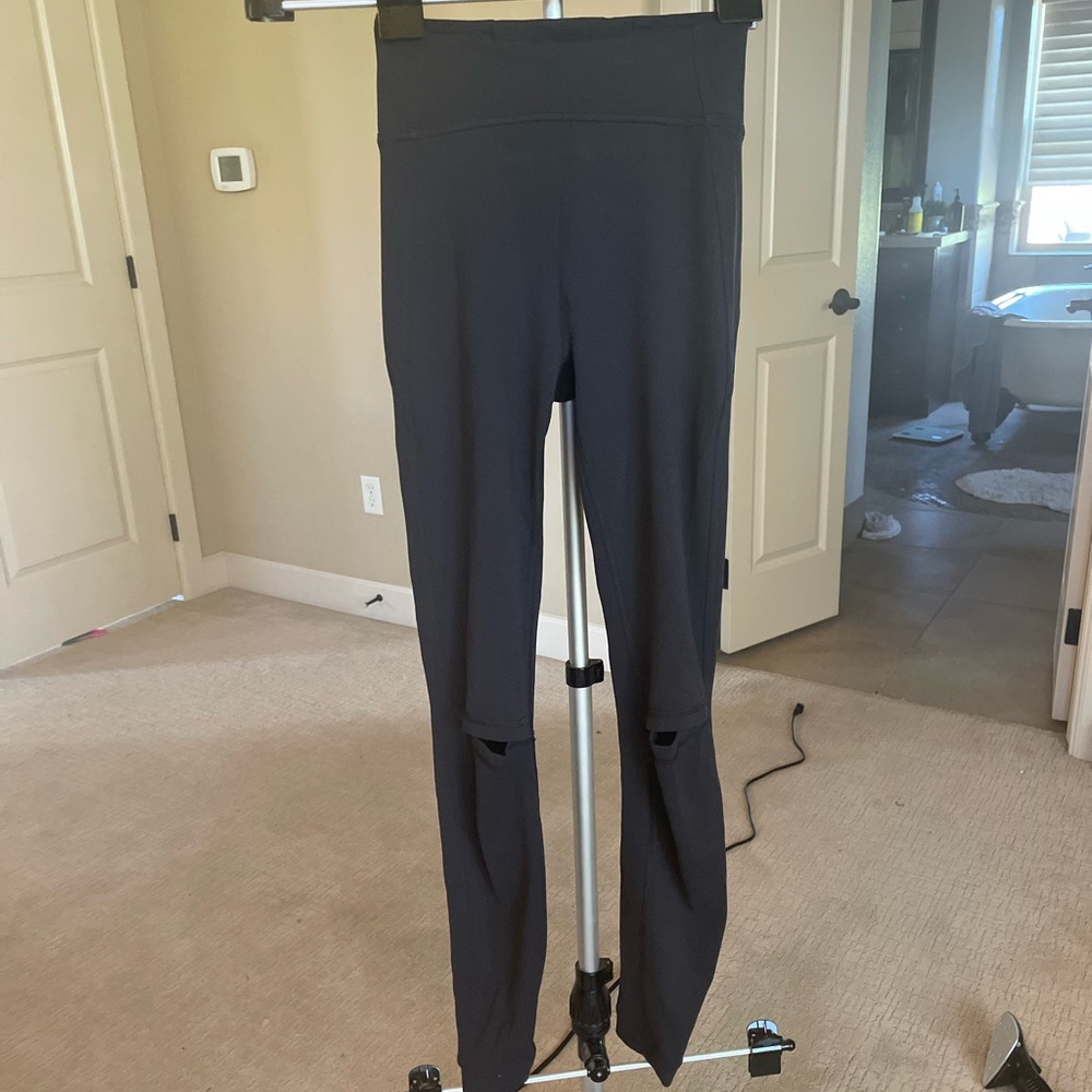 Lululemon black leggings with cutouts at knees. Size 2. No flaws.